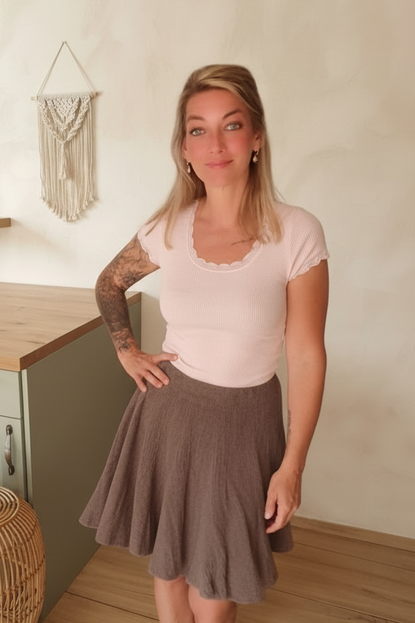 Boho-Luxe Outfit: Hellrosa Ripp-Top aus Baumwolle und brauner Faltenrock.