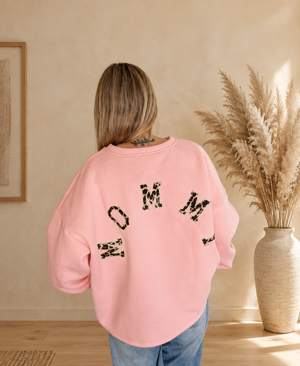 Rückansicht des rosa Oversize-Sweatshirts für Damen mit großem MOMMY-Schriftzug im Leomuster.